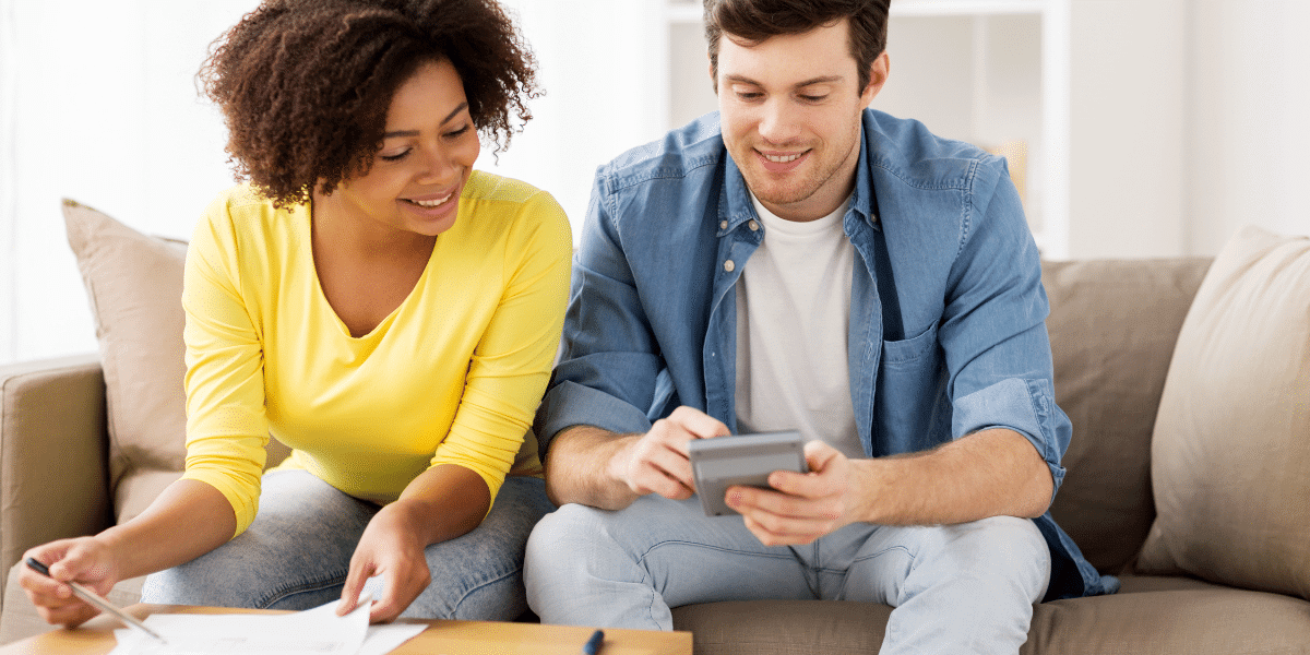 A couple sitting together planning their budget