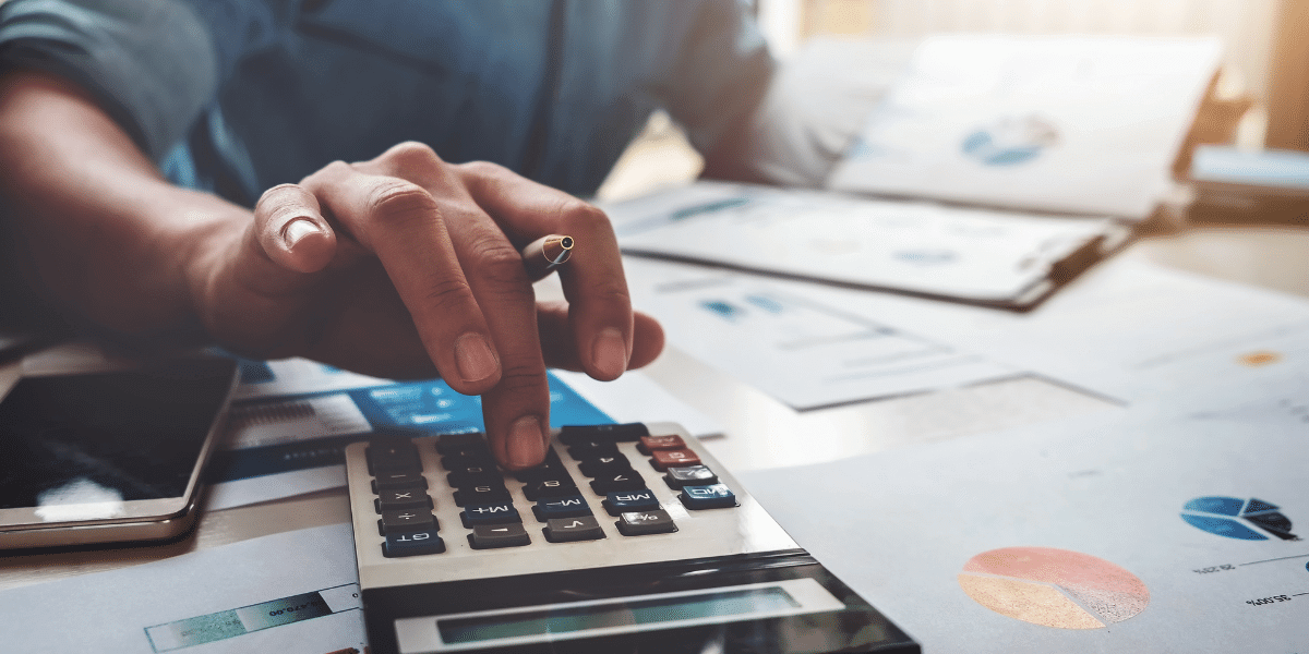 Person using a calculator to create a budget