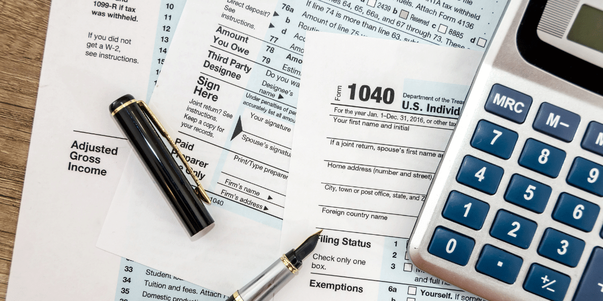 1040 tax forms and a calculator